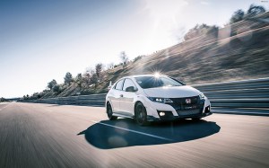 An FK2 Civic driving along a public road.