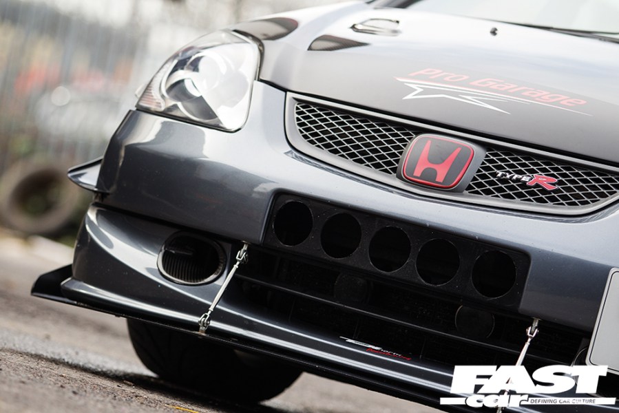 A low shot of the front right corner of a grey Honda Civic Type R